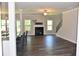 Cozy living room featuring a fireplace, hardwood floors, and plenty of natural light at 480 Brown Dove Ln, Grayson, GA 30017