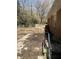 Backyard featuring a concrete patio, chainlink fence, and natural greenery on a sunny day at 982 Scott Cir, Decatur, GA 30033