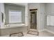 This bright bathroom includes a tub, a shower and neutral wall color at 11020 Bradford Ln, Suwanee, GA 30024