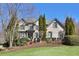 Charming brick home featuring manicured lawn, mature trees, and a traditional architectural design at 11020 Bradford Ln, Suwanee, GA 30024