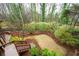 Scenic backyard featuring stairs, lush greenery, and a variety of trees at 1207 Woodlawn Ne Dr, Marietta, GA 30068