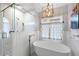 Luxurious bathroom with a standalone tub and separate glass-enclosed shower at 1207 Woodlawn Ne Dr, Marietta, GA 30068