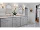 Bathroom featuring double sink vanity with marble countertop, neutral paint, and tile floor at 1207 Woodlawn Ne Dr, Marietta, GA 30068