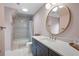 Bright bathroom featuring vanity with marble countertop, grey cabinetry, and a tub-shower combo at 1207 Woodlawn Ne Dr, Marietta, GA 30068