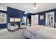 Bedroom with blue accent walls, a ceiling fan, two chairs and access to the en suite bathroom at 1207 Woodlawn Ne Dr, Marietta, GA 30068