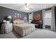 Bedroom with dark grey walls, two windows, piano, and wooden bed, with decorative accessories at 1207 Woodlawn Ne Dr, Marietta, GA 30068