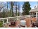 Relaxing deck with ample seating, outdoor grill, and natural wooded backdrop at 1207 Woodlawn Ne Dr, Marietta, GA 30068