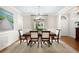 Formal dining room with large painting, chandelier, and views of the home's entry at 1207 Woodlawn Ne Dr, Marietta, GA 30068