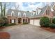 Inviting brick home with a two-car garage and manicured front yard at 1207 Woodlawn Ne Dr, Marietta, GA 30068