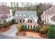 Beautiful two-story home featuring a classic brick facade and lush landscaping at 1207 Woodlawn Ne Dr, Marietta, GA 30068