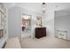 Upstairs hallway with view to bedroom, art-lined wall, and decorative chandelier at 1207 Woodlawn Ne Dr, Marietta, GA 30068