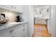 View into bright kitchen with white cabinets, marble countertops, stainless steel appliances at 1207 Woodlawn Ne Dr, Marietta, GA 30068