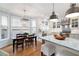 Gourmet eat-in kitchen area featuring modern appliances, granite countertops, and bright lighting at 1207 Woodlawn Ne Dr, Marietta, GA 30068