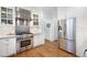 Well-equipped kitchen with stainless steel appliances and white cabinetry at 1207 Woodlawn Ne Dr, Marietta, GA 30068