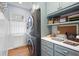 Well-organized laundry room featuring a stackable washer/dryer and built-in desk area at 1207 Woodlawn Ne Dr, Marietta, GA 30068