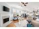 Open-concept living room with fireplace that flows into a dining area and modern kitchen at 1207 Woodlawn Ne Dr, Marietta, GA 30068