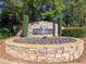 Stone community sign for Indian Ridge, surrounded by colorful flowers and greenery at 1326 Nantahala Ne Trl, Marietta, GA 30062