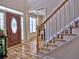 Bright foyer featuring hardwood floors, staircase with white railings, and natural light at 1326 Nantahala Ne Trl, Marietta, GA 30062