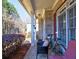 Relaxing front porch featuring dark wicker seating, potted plants, and a view of the front yard at 1326 Nantahala Ne Trl, Marietta, GA 30062