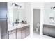 Elegant bathroom featuring dual vanities with white countertops and modern fixtures at 2141 Hempstead Ct, Snellville, GA 30078