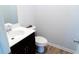 Half bathroom featuring a modern vanity and hardwood floors at 2141 Hempstead Ct, Snellville, GA 30078