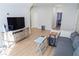 Bright living room featuring wood floors, gray couch, and TV at 2141 Hempstead Ct, Snellville, GA 30078