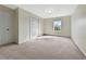 Cozy bedroom features neutral carpet and walls, with a closet and window, providing ample natural light at 242 Meadow Spring Dr, Temple, GA 30179