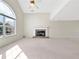 Bright living room with high ceilings, fireplace, and a large window, creating an inviting space at 242 Meadow Spring Dr, Temple, GA 30179