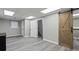Finished basement area with modern flooring and a rustic barn door at 266 Carthage Blvd, Rockmart, GA 30153