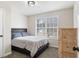 Cozy bedroom features a bed, a window with natural light, and a wood dresser, providing a comfortable resting space at 266 Carthage Blvd, Rockmart, GA 30153