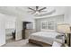 Comfortable bedroom with a TV, wooden dresser, large window, and ceiling fan for optimal lighting and airflow at 266 Carthage Blvd, Rockmart, GA 30153