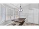 The dining area offers a lot of natural light from the window, a modern light fixture and laminate flooring at 266 Carthage Blvd, Rockmart, GA 30153