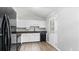 Modern kitchen features white cabinets, a black dishwasher, and laminate flooring, creating a clean and functional space at 266 Carthage Blvd, Rockmart, GA 30153
