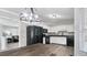 Open kitchen with black appliances, white cabinetry, and an eat-in dining area, creating a cozy culinary space at 266 Carthage Blvd, Rockmart, GA 30153