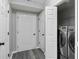 Laundry area featuring a pair of modern gray front-load washing machines and a gray floor at 266 Carthage Blvd, Rockmart, GA 30153