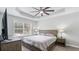 Relaxing main bedroom featuring a tray ceiling, neutral paint, ceiling fan and natural light at 266 Carthage Blvd, Rockmart, GA 30153