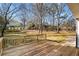 A wood deck overlooks the lush backyard with mature trees at 795 Saddle Ridge Trce, Roswell, GA 30076