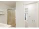 Bathroom showcasing a sliding glass shower, tiled walls, and a storage cabinet above sink at 795 Saddle Ridge Trce, Roswell, GA 30076