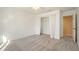 Neutral bedroom featuring plush carpeting, a ceiling fan, and an open closet with sheer curtains at 795 Saddle Ridge Trce, Roswell, GA 30076