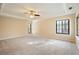 Spacious bedroom featuring neutral carpet, tray ceiling, and windows letting in plenty of natural light at 795 Saddle Ridge Trce, Roswell, GA 30076