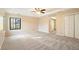 A carpeted bedroom boasts natural light, walk-in closet, and neutral walls for a relaxing space at 795 Saddle Ridge Trce, Roswell, GA 30076