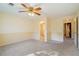 Large bedroom featuring neutral walls and carpet, a ceiling fan, and multiple doorways at 795 Saddle Ridge Trce, Roswell, GA 30076