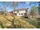 View of the back of the house with a deck and a large backyard at 795 Saddle Ridge Trce, Roswell, GA 30076