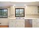 Well-lit kitchen with white cabinets, neutral countertop, and double windows at 795 Saddle Ridge Trce, Roswell, GA 30076