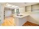 Bright kitchen featuring white cabinets, an island cooktop, and hardwood flooring at 795 Saddle Ridge Trce, Roswell, GA 30076