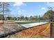 View of the community playground with green slides, volleyball court, and soft turf at 795 Saddle Ridge Trce, Roswell, GA 30076