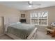 Cozy bedroom with neutral paint, a ceiling fan, and a large window at 8116 Powhattan Ct, Mcdonough, GA 30252