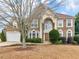 Beautiful brick home with arched windows, manicured landscaping, and a two-car garage at 8116 Powhattan Ct, Mcdonough, GA 30252