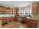 Traditional-style kitchen featuring wood cabinets, granite countertops, stainless steel appliances, and hardwood flooring at 8116 Powhattan Ct, Mcdonough, GA 30252