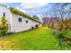 The expansive backyard features green grass, mature trees, and view of the side of the house at 106 Lanyard Bnd, Peachtree City, GA 30269